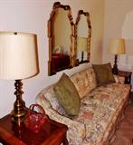 Custom upholstered couch side tables, gilt mirrors, solid brass lamps