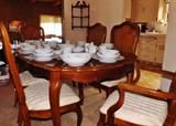 A beautiful dining room set with six upholstered chairs and two leaves