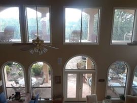 The dramatic architecture sets the stage. See wicker furniture on upstairs gallery and furniture on the pool level