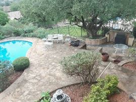 Looking down from the upstairs gallery. Patio furniture in various locations around the pool. Practical and very affordable tables and chairs. Antique wicker is located on the ground level as well.