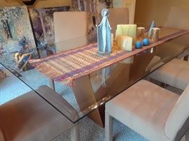 Lladro figure on table. Three large impressionistic decorative pictures are shown in background