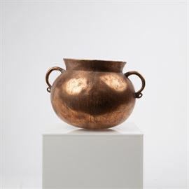 A SOUTH AMERICAN HAMMERED COPPER OLLA