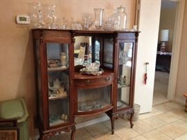 French style etagere with curved glass door.