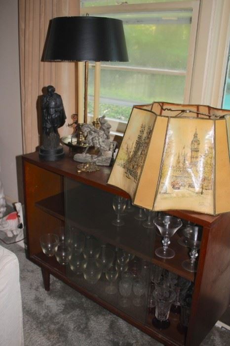 Assorted Decorative Statues, Credenza and Stemware with Lamp and Vintage Stenciled Lamp Shade