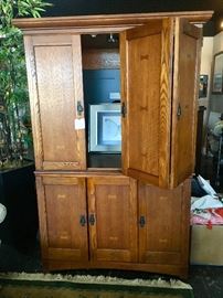 We have two different large wooden entertainment centers