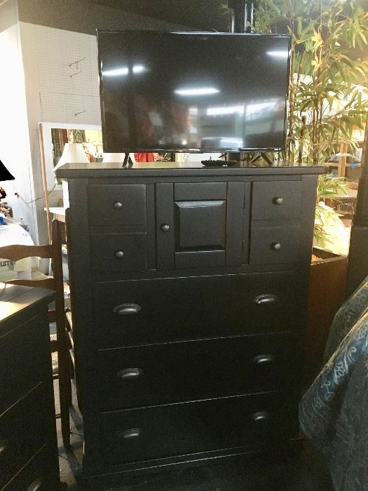 Black Chest of Drawers with brushed silver pulls and small flat screen TV