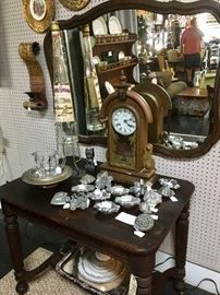 Vintage foyer table with drawer, Fostoria Coin Pitcher, Antique Clock, tall liquor decanter on metal stand with spout, wooden framed mirror, and vintage ice cream molds