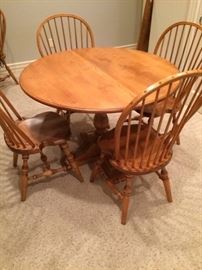 Dining table and chairs that were handmade in the Sheboygan area. The quality and detail are outstanding. The table is a 42" round without the leaf. With leaf inserted it becomes a 58" oval with a width of 42". Included are the 6 matching chairs with an approximate measurement of 39"high x 21"wide. Seat height is 17". Both table and chairs are solid maple. Perfect condition!!!