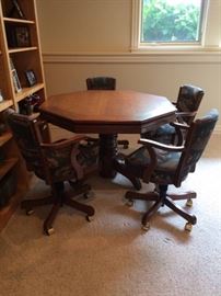 Beautifully designed game table and chairs features bumper pool and poker table. The adjustable chairs are in perfect condition along with the table itself. Each chairs upholstery depicts a unique vintage sport. Included of course are the balls and 2 queue sticks. The octagonal table measures 48" x 48", and the chairs are approximately 31"high.