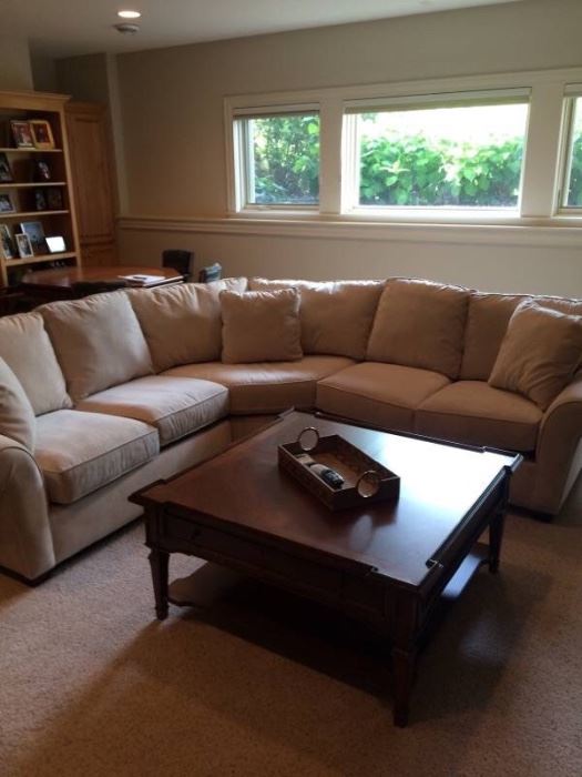  The off white fabric upholstery is in perfect condition showing no signs of staining, odors or wear. This is a large sofa, measuring about 107"x107".