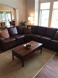 Absolutely stunning large leather sectional sofa. This was purchased at Boston Store and was perfect for the old house. Unfortunately, tastes have changed and a different style sofa is on its way to the new home. This was sold under the "Boston Store" private label and is in perfect condition. The leather is in dark brown and is very soft and supple. It also feature nail head trim along the bottom. The last section of each side also features a reclining motion feature. Very, very comfortable. The leather is top quality and should not be confused with the low end leather finishes referred to as "bonded". This is a large piece, measuring approximately 102" x 126". I have included a very rough sketch of the overall dimensions and shape. 