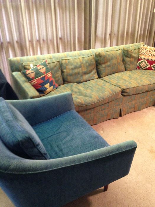 Three-cushion vintage sofa and one of two blue modern chairs