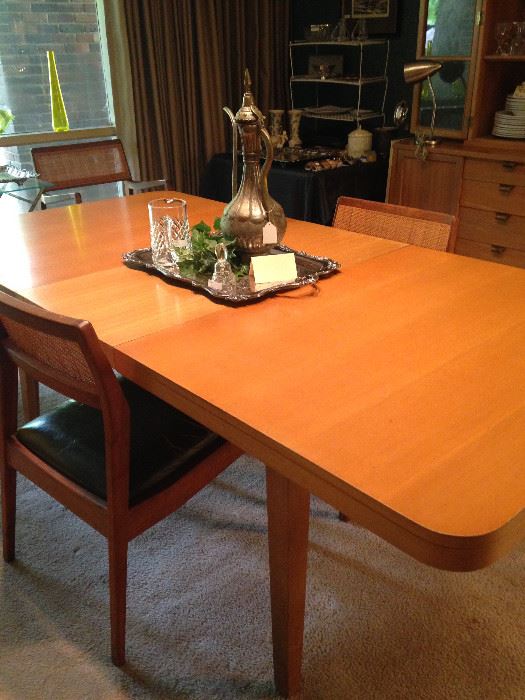 This Mid-Century dining table has 4 chairs.