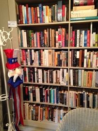 Huge selection of books; white metal hat rack; Uncle Sam flag