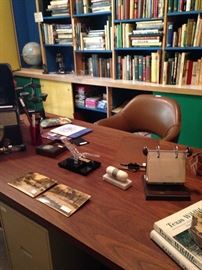 The large desk of Dr. Hascall Muntz backed by many books