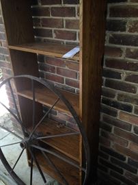 Book case and old wagon wheel