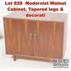Lot 828 Modernist Walnut Cabinet. Tapered legs  decorati