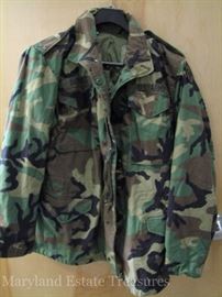 U.S. Army camouflage coat with the liner in size 36L. Rank pins still on shoulders and unit patch on upper left sleeve.