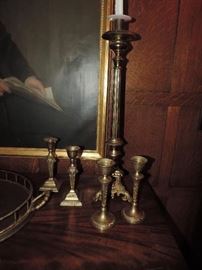 many vintage and contemporary brass candlesticks 