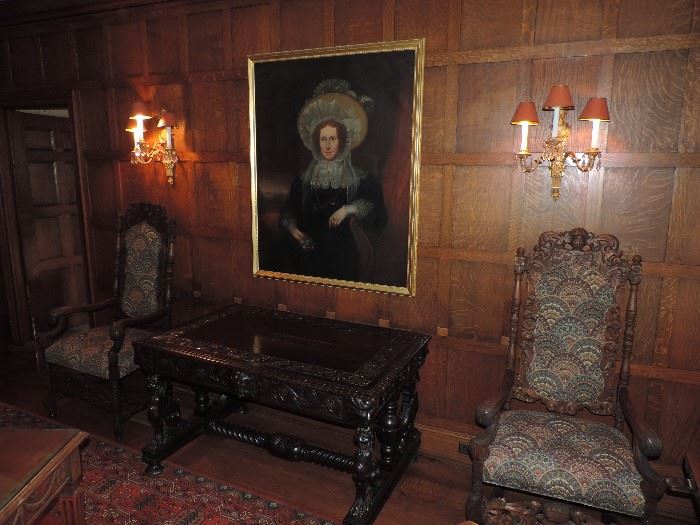 Overview of another wall in the Dining Room. Shown is a life size portrait of "Lady of the Manor",  pair of English high-back armchair with modern upholstery.  (Scones are not for sale - the griffin table previously for sale has been retained by the family.