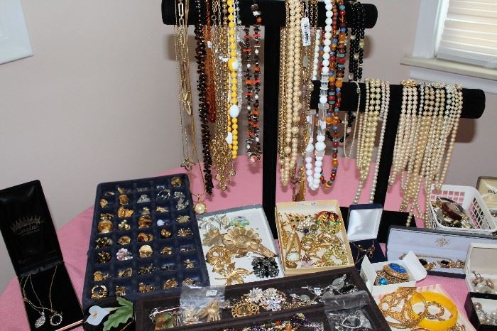 Tons of jewelry including some gold rings and some sterling silver pieces.