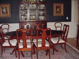 Double pedestal mahogany dining table with pads, six Queen Anne style chairs