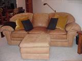 Well-maintained leather sofa, ottoman with matching club chairs and ottomans