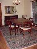 Walnut table with several leaves.  Six dining chairs.  Mahogany buffet