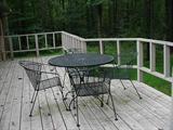 Round wrought iron table with four arm chairs