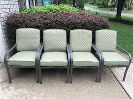 Set of four patio chairs with little wear.