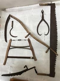 Antique two-man cross-cut saw, buck/bow saw, scythes.