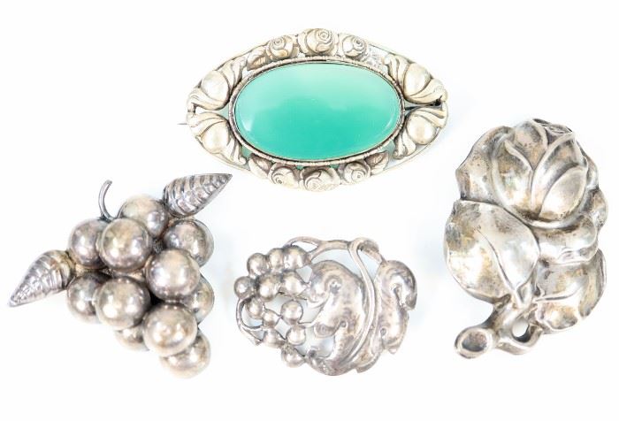 Four Sterling and Silver Brooches - Danish style, naturalistic motifs including one stamped "DKS/800", one "Baur Sterling", one "Silver Mexico", and one unmarked inset with green stone. Minor wear, pin backs are bent. Up to 2 1/2" wide. 
