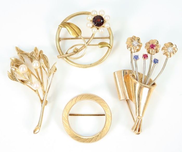 Four Yellow Gold Brooches - Including 1 round 10 kt yellow gold brooch with pearl and garnet flower, 1 14 kt yellow gold round brooch, 1 14 kt yellow gold and gemstone bouquet of flowers brooch, and 1 14 kt yellow gold and pearl leafy branch form brooch.  All are marked accordingly.  Minor wear to each.  Up to 2" long.  Totaling 25.9 grams. 
