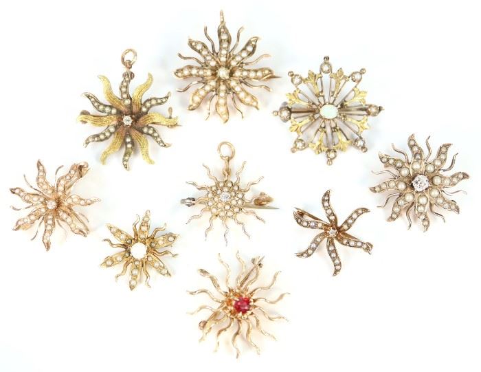 A Group of Nine 19th & 20th Century Starburst Brooches - Each clad with either enhancement gemstones, including opals, or pearls. One stamped "14 k", another "10 k", the rest are unmarked. Minor wear to each, with two missing a seed pearl each. Up to 1" in diameter. Totaling 27.8 grams. 
