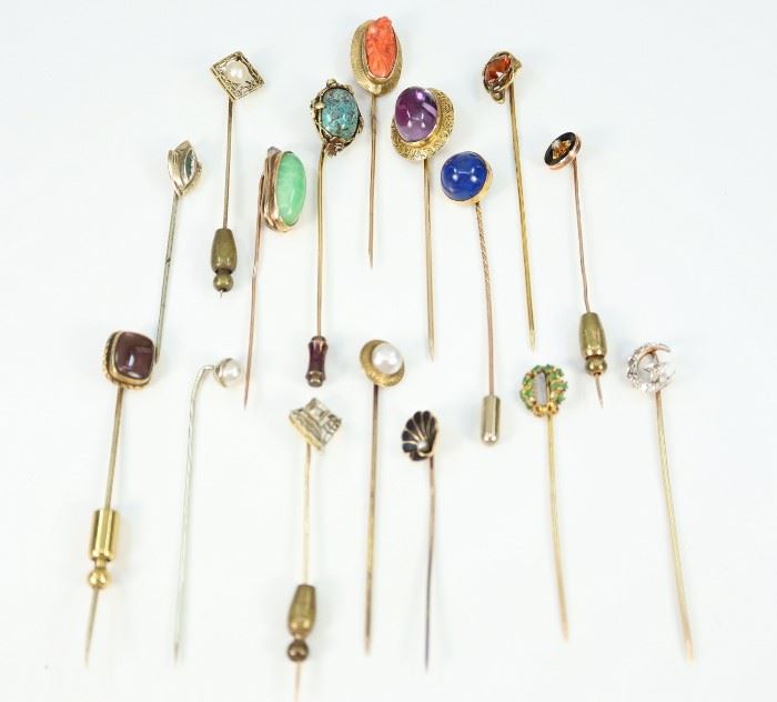 Sixteen 19th Century Stick Pins - Of various sizes and designs, all are marked as "14 kt" gold. Enhancements include: diamonds, pearls, cameo shell, enamel, turquoise, lapis, and jade. Overall wear, small losses to one with enamel and some with misshapen pins. Up to 2.75" long. Totaling 38.7 grams. 
