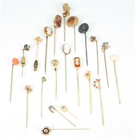 Twenty-One 19th Century Stick Pins - Consisting of one marked "Sterling"  sliver pin, one marker "10 k" gold, along with nineteen unmarked pins decorated with various real and synthetic gemstones and enhancements. Wear noted overall, with some bent or misshapen pins, and one with horseshoe lacking some decoration. Up to 3" long. Totaling 39.4 grams. 