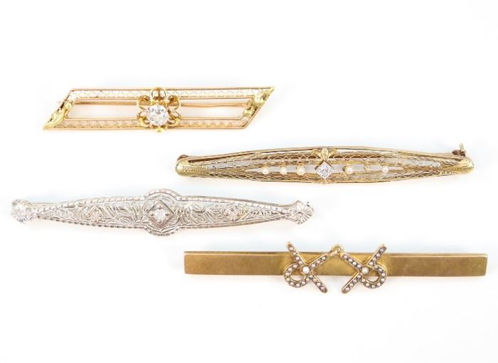 Four 19th & 20th Century Gold, Diamond & Pearl Bar Pins - Including one 10 kt yellow gold bar pin with floriform design and solitaire stone, one 18 kt white gold filigree bar pin with three diamond enhancements, and two 14 kt yellow gold bar pins: one with seed pearl accents, and the other with filigree design along with seed pearl and diamond adornments. All are marked according. Minor wear to each, two with misshapen pin backs, and the seed pearl decorated pin appears to be lacking an adornment. Up to 2.5" long. Totaling 17.5 grams. 
