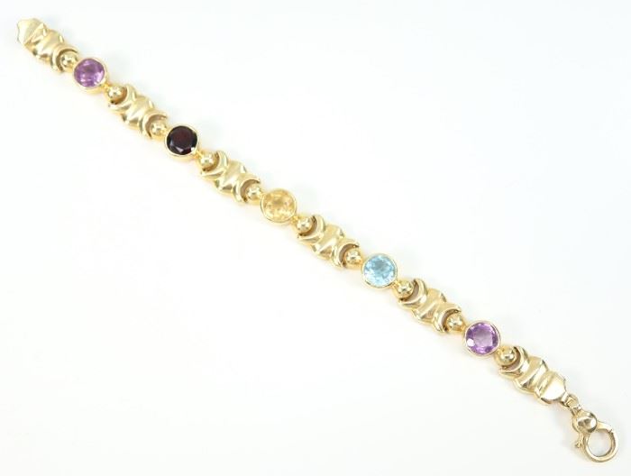 A 14 kt Yellow Gold & Semi-Precious Stone Bracelet -  Yellow gold bracelet set with 5 gemstones including amethyst and garnet.  Stamped "14 Kt Italy" and "RZN".  Minor wear noted.  7 1/4" long.  Totaling 25.2 grams.
