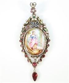 An 18th Century Georgian Mourning Pendant - Finely painted with a figure of a young shepherdess and two sheep, the scene is beautifully enhanced by colored Paste, seed pearls, and enameled decoration; verso contains a space to contain a lock of hair.  Minor wear, overall in good condition.  1" wide x 2 3/4" high.  
