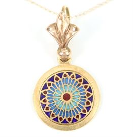 An 18 kt Yellow Gold & Plique-a-Jour "Notre Dame" Pendant -  Modeled after a Rose Window at Notre Dame Cathedral in Paris.  Marking consists of a profile of an eagle, not enclosed, indicating fineness of 18 kt.  Suspended from a Fleur-de-lis and a chain marked "14 K", of varying dates.  Minor wear.  Approximately 10" long.  Totaling 2.3 grams. 