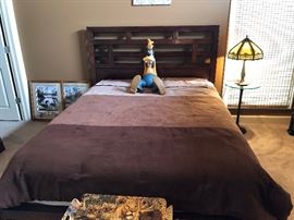 Large Goofy Statue on Queen Size Mission Style Bed