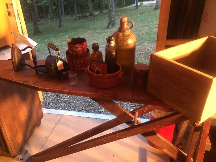 Wooden ironing boards with irons, old judge coffee advertising, old crocks, many old crates with advertising