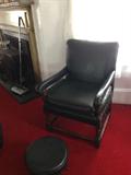 Quality leather chair has a matching stool with it.