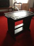 Antique table has a tray top for easy serving.