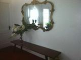 Completely elegant bench with huge mirror. This looks like a great place for family photos.