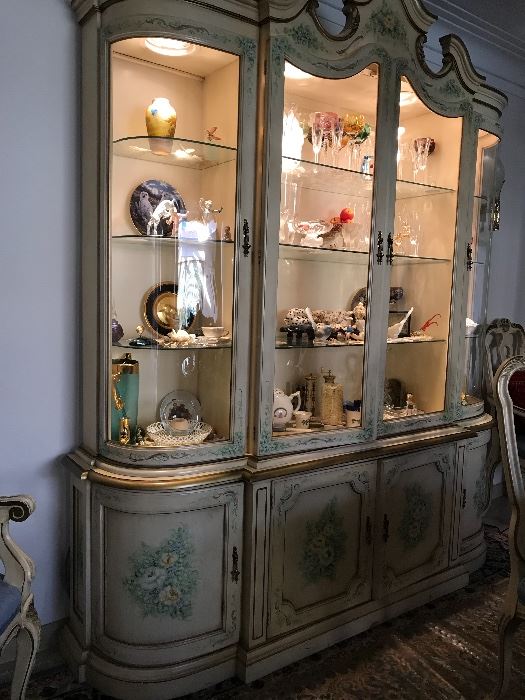 Lighted, handpainted and gilt trimmed china cabinet. 