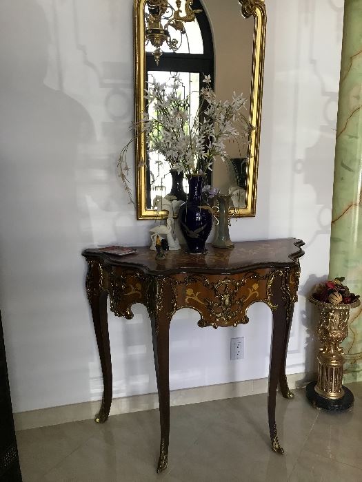 Valencia, Spain. Louis XV style console table shown with tall 24kt gold painted hall mirror.  