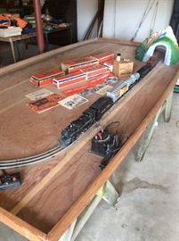 This is a must see.  Lionel Train.  Tracks are on Board.  Books, Pellets and Smoke.  Boxes in fair condition.  Transformer needs repaired