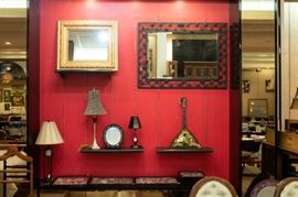 We have several mirrors and lamps...Below those are shadow boxes filled with items collected from different parts of the world.
