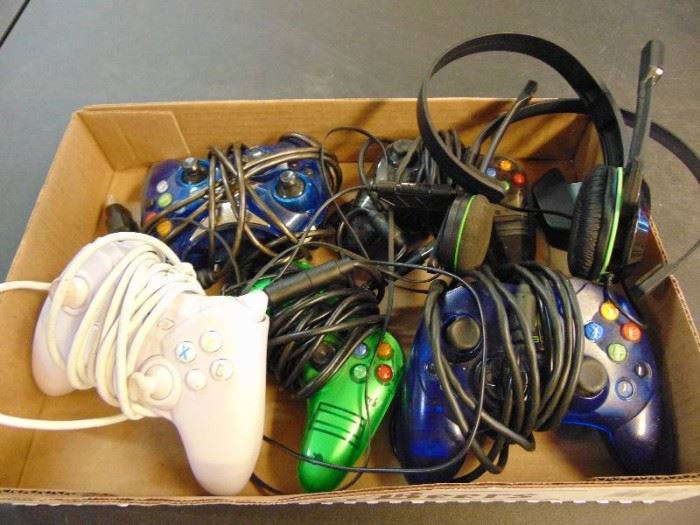 Lot of Xbox controllers headphones.